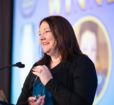 Karine Guimond of Mary Kay accepting the award on behalf of France Grenier.